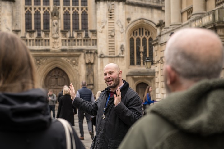 a person standing in front of a building talking on a cell phone