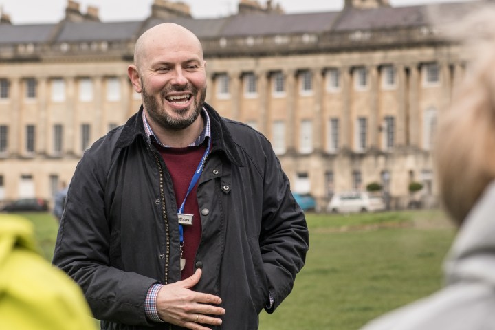 a man standing in front of a building