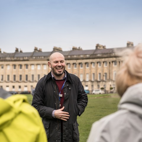 a couple of people that are standing in the grass