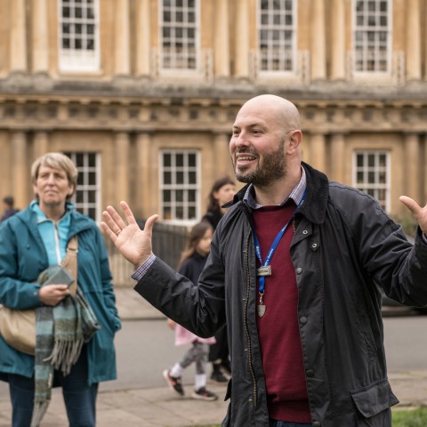 a group of people walking in front of a building