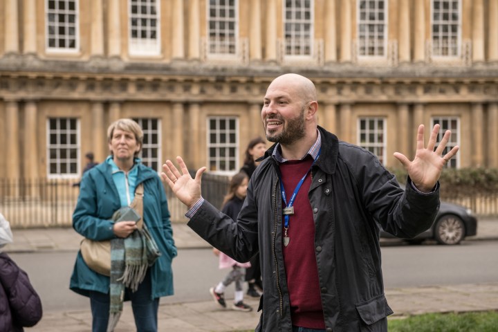 a group of people walking in front of a building