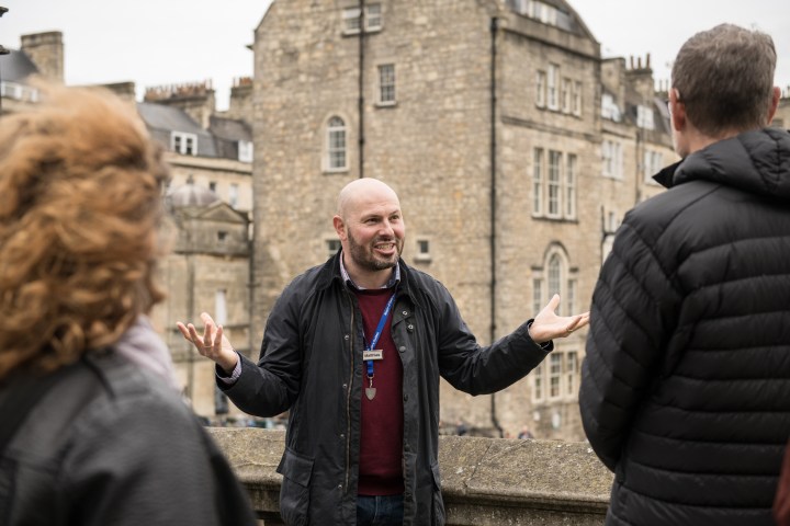 a man and a woman standing in front of a building