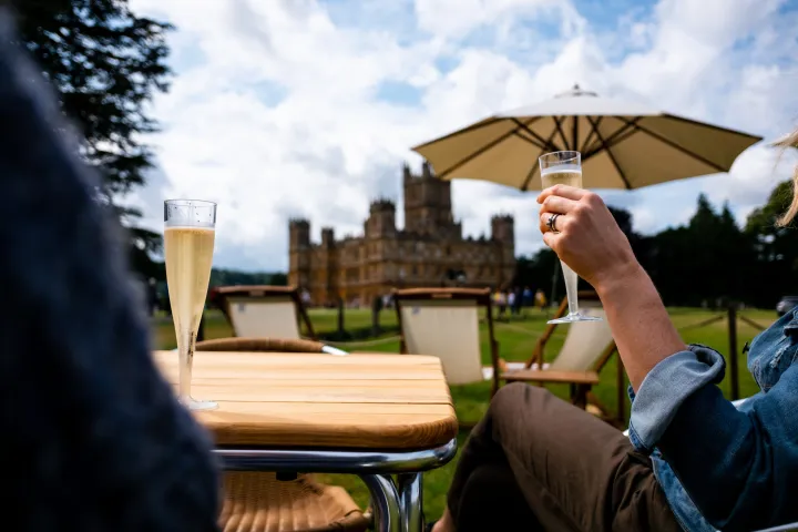a person sitting at a table with a blue umbrella