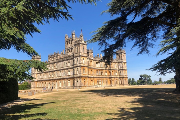 a large tree in front of Highclere Castle