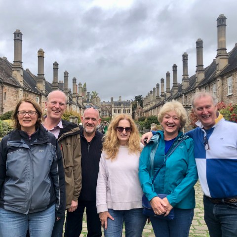 Francoise Sagan et al. posing for a photo in front of a building