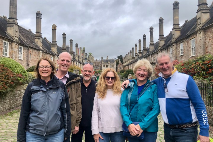 Francoise Sagan et al. posing for a photo in front of a building