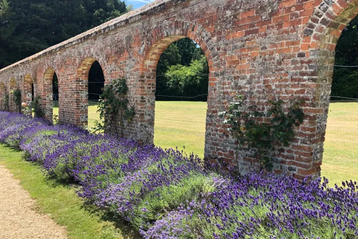 a large brick building with grass and trees