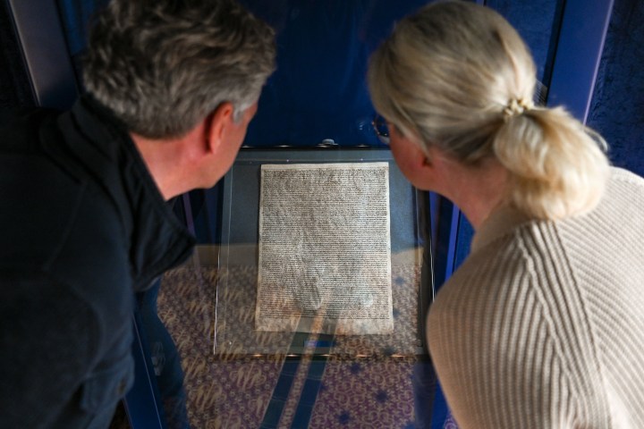 a man standing in front of a laptop