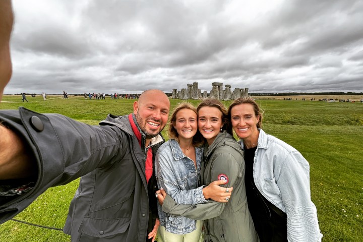 a man standing on a grass field posing for the camera