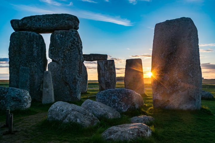 a stone building with Stonehenge in the background